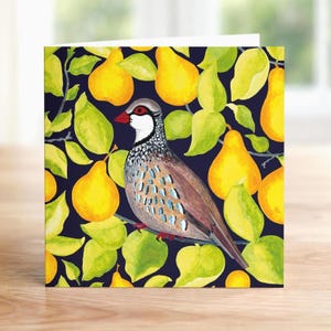 May include: Greeting card featuring a watercolor illustration of a bird perched on a branch, surrounded by yellow pears and green leaves against a dark blue background. The bird has brown, white, and blue markings.