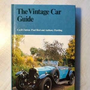 May include: A blue vintage car book titled "The Vintage Car Guide" by Cecil Clutton Paul Bird and Anthony Harding. The cover features a photo of a blue vintage car with a black chassis and a license plate that reads "DR-3634".