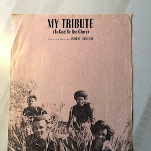 May include: A black and white photo of a group of four people standing in a field of tall grass. The photo is from a sheet music cover for the song "My Tribute (To God Be The Glory)" by Andrae Crouch. The text "Lexicon Music, Inc. Distributed by WORD, INC., Waco, Texas 76703" is at the bottom of the photo.