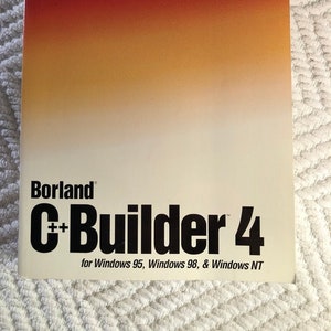 May include: A red, orange, and yellow gradient cover for a Borland C++ Builder 4 Developer's Guide for Windows 95, Windows 98, and Windows NT.