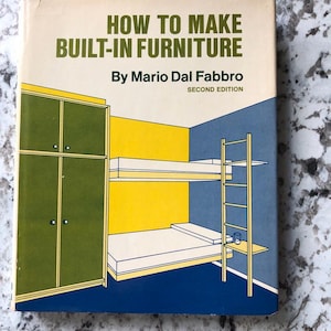 May include: A vintage book titled "HOW TO MAKE BUILT-IN FURNITURE" by Mario Dal Fabbro. The cover features an illustration of a room with bunk beds, a cabinet, and a ladder, in shades of green, yellow, blue, and white.