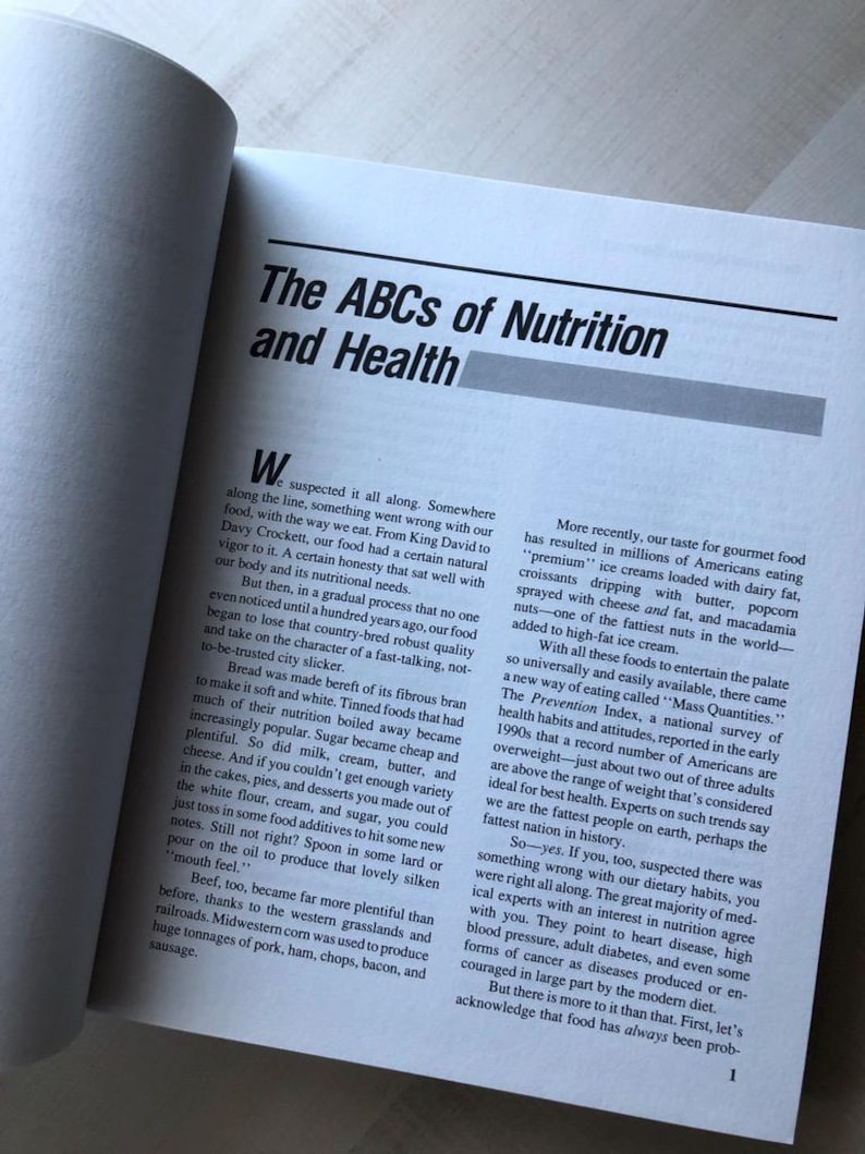 May include: A book page with the title "The ABCs of Nutrition and Health" and a section discussing the history of food and how it has changed over time. The text mentions the shift from natural, wholesome foods to processed and refined foods, and the impact this has had on health.