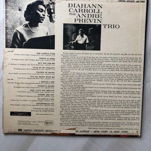 May include: A vintage vinyl record cover featuring a black and white photo of Diahann Carroll, a singer, with a microphone. The cover also features the text "Diahann Carroll The Andre Previn Trio" and "United Artists UAL 3069".