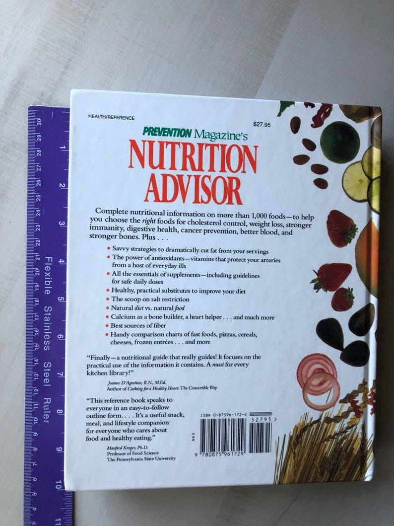 May include: A green and white book titled "Prevention Magazine's Nutrition Advisor" with a red and white barcode on the back. The book cover features a colorful image of various fruits and vegetables.