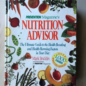 May include: A white book with a colorful cover featuring a variety of fruits and vegetables. The title is "Prevention Magazine's Nutrition Advisor: The Ultimate Guide to the Health-Boosting and Health-Harming Factors in Your Diet" by Mark Bricklin and the Editors of Prevention Magazine. The book cover also states "Over 1,000 Foods Analyzed & Rated".