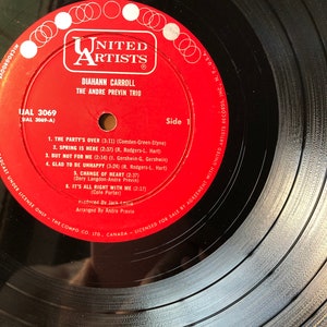 May include: A red vinyl record with the title "The Party's Over" by Diahnne Carroll and The Andre Previn Trio. The record is from United Artists Records and is labeled as side 1. The record is a 33 1/3 RPM record.
