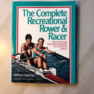 May include: A book cover with a teal background and a red and white title: "The Complete Recreational Rower & Racer". The subtitle is "From Indoor Rowing Machines to Outdoor Shells". The cover features a photo of two people rowing a boat.