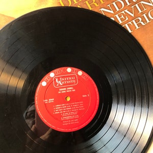 May include: A black vinyl record with a red label. The label has the text "United Artists" and "Diann Carroll" with the title "The Andre Previn Trio". The record is labeled "Side 2" and has the song titles "I Should Care", "Nobody's Heart", "Why Can't You Behave", "Where Are You", "In Love In Vain", "Sing, Sing, Sing", "Everybody's Got Joy", and "The Sing-Along Joy (2:00)".