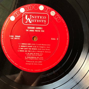 May include: A red vinyl record label with the title "United Artists" in white lettering. The record is by "Diahnne Carroll" and "The Andre Previn Trio". The record is "UAL 3069" and is side 2. The record includes the song titles "I Should Care", "Nobody's Heart", "Why Can't You Behave", "Where Are You", "In Love In Vain", and "Gingerbread Joy".