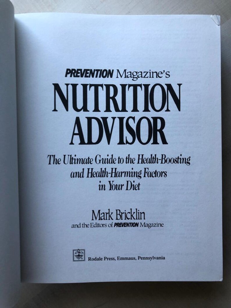 May include: A book titled "PREVENTION Magazine's NUTRITION ADVISOR: The Ultimate Guide to the Health-Boosting and Health-Harming Factors in Your Diet" by Mark Bricklin and the Editors of PREVENTION Magazine. The book cover is white with black text and a small logo at the bottom.