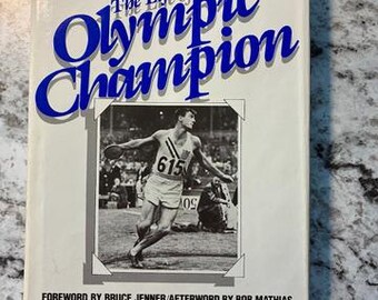 Signed. Nearly Fine Vintage Condition "Bob Mathias The Life of the Olympic Champion - M. Tassin" 1983 1st Edition Hardcover and Dust Jacket