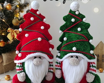 May include: Two crocheted Christmas gnomes wearing red and green tree hats with white pom-poms. The gnomes have white beards and are sitting on a woven basket.