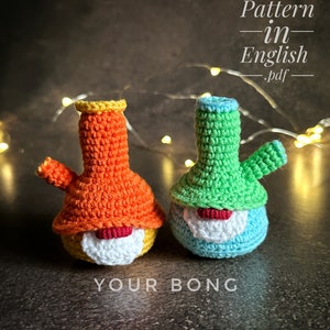 May include: Two crocheted gnome-like figures, one orange and one green, with white beards and red noses. The figures are shaped like bongs and have a "YOUR BONG" text below them. The pattern for these figures is available in English.