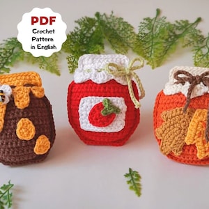 May include: Three crocheted jars, one with a honey bee and dripping honey, one with a red lid and a red tomato, and one with a brown lid and a brown leaf.  PDF Crochet Pattern in English.