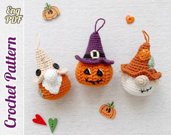 May include: Three crocheted Halloween ornaments: a pumpkin with a witch's hat, a pumpkin with a grumpy face, and a gnome with a brown hat and beard.