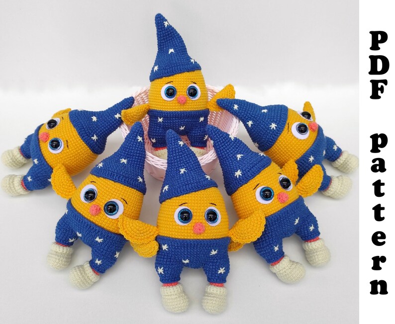May include: Six crocheted stuffed toys in the shape of a yellow bird wearing a blue and white hat. The toys are arranged in a circle around a white basket.
