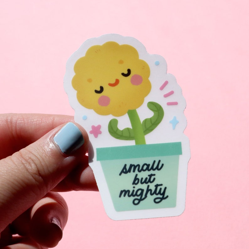 May include: A yellow flower with a smiling face in a green pot with the text "small but mighty".