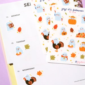 May include: A sheet of stickers featuring cute ghost illustrations with fall-themed designs. The stickers include ghosts holding pumpkins, turkeys, and pie. The text "yay! it's falloween by VICA" is printed on the sheet.
