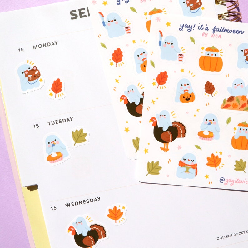 May include: A sheet of stickers featuring cute ghost illustrations with fall-themed designs. The stickers include ghosts holding pumpkins, turkeys, and pie. The text "yay! it's falloween by VICA" is printed on the sheet.
