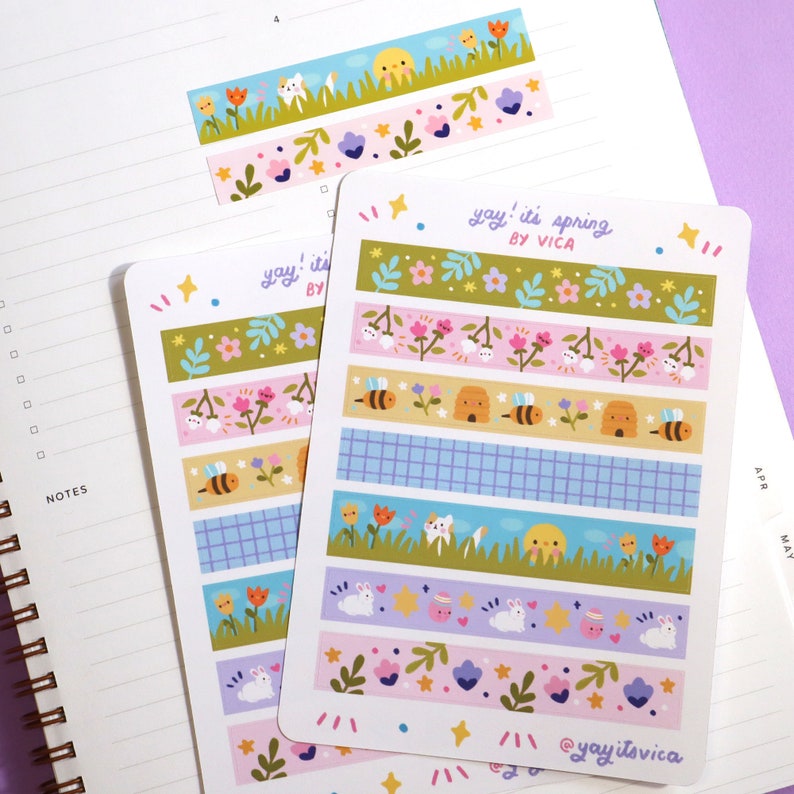 May include: Sheets of decorative washi tape stickers with spring-themed designs. The stickers feature illustrations of flowers, bees, bunnies, and other seasonal elements. The text "yay! it's spring by Vica" is printed on the sticker sheets.