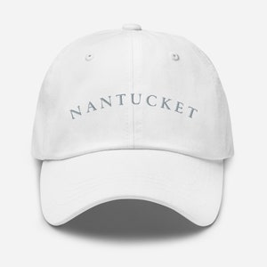 Può includere: Cappellino da baseball bianco con la parola "NANTUCKET" ricamata in grigio sul davanti.