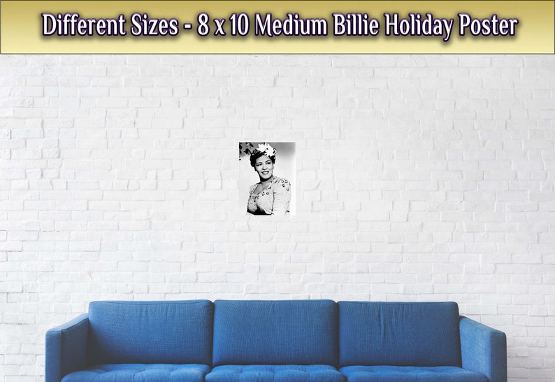 May include: A black and white photo of Billie Holiday, a famous jazz singer, wearing a floral hat and a dress. The photo is framed and hanging on a white brick wall.