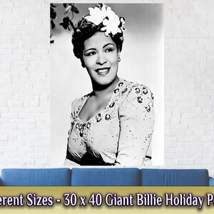 May include: Black and white poster featuring a portrait of Billie Holiday. She is wearing a white blouse with sequins and a white flower in her hair. The poster is 30 inches by 40 inches.