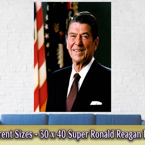 May include: A poster featuring a portrait of Ronald Reagan, the 40th President of the United States. He is wearing a dark suit and a red tie. The American flag is visible in the background. The poster reads "Different Sizes - 30 x 40 Super Ronald Reagan Poster".