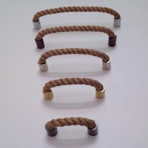 May include: A collection of five rope-style cabinet pulls. The pulls are made of twisted brown rope with metal end caps in silver, bronze, and gold tones. The pulls are arranged in a descending order.