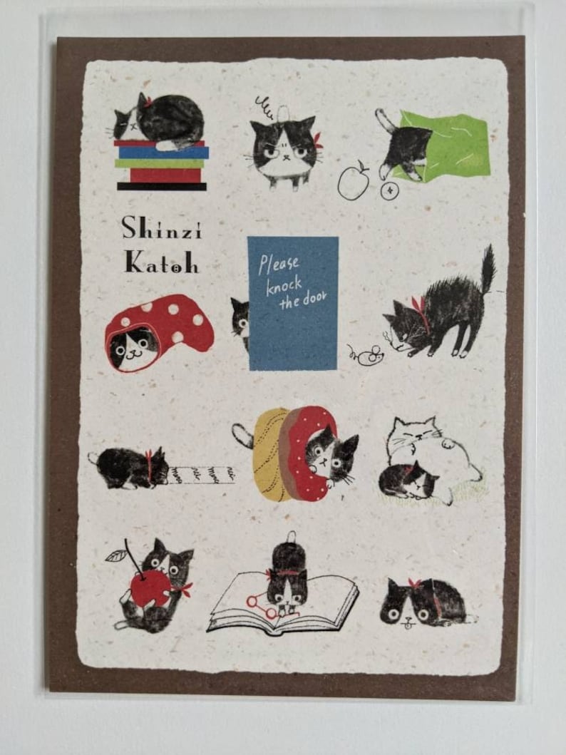 May include: A postcard featuring illustrations of black and white cats in various poses. The postcard has a brown border and a white background with black text that reads "Shinzi Katoh" and "Please knock the door".