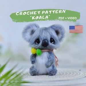May include: Crochet pattern for a gray and white koala amigurumi toy with a yellow and green bow. The pattern includes a PDF and video instructions.