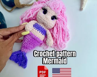 May include: A handmade crochet mermaid doll with pink hair, purple tail, and a striped top. The doll has large eyes and long eyelashes. The image includes the text "Crochet pattern Mermaid" and a PDF icon with the American flag.