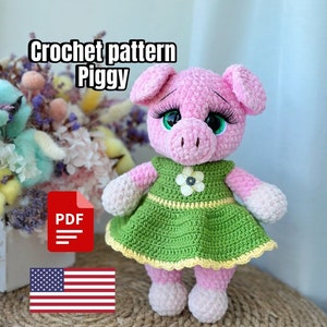 May include: Crochet pattern for a pink pig wearing a green dress with a yellow flower. The pattern is available as a PDF download. The image also includes the American flag.
