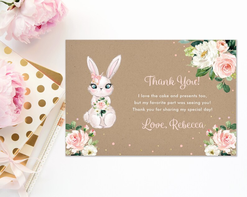 May include: Thank you card with a white bunny holding pink flowers, surrounded by pink and white flowers on a brown background. The text reads "Thank You! I love the cake and presents too, but my favorite part was seeing you! Thank you for sharing my special day! Love, Rebecca."