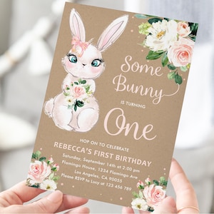 May include: A brown paper card with a white bunny holding pink flowers. The card has the text "Some Bunny is Turning One" and details for a first birthday party.