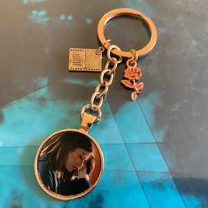 Slasher Charms Sweet Killer The Boy Horror Movie Brahms Heelshire and Greta Evans Brahms Doll Rose Card Inspired Charm Key Chain