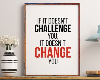 May include: A motivational quote in a black and red frame on a white wall. The quote reads "If it doesn't challenge you, it doesn't change you".
