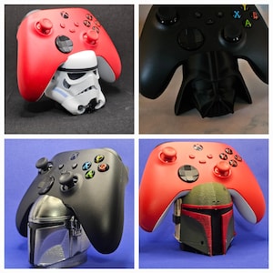 May include: Four different colored Xbox controllers with various character stands. The controllers are black, red, and white. The stands are a Stormtrooper, Darth Vader, a Mandalorian, and a Boba Fett.
