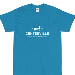 May include: A turquoise blue t-shirt with a white graphic of the outline of Cape Cod, the text "INC. 1639", "CENTERVILLE", and "CAPE COD".