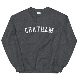 May include: A dark gray sweatshirt with the word "CHATHAM" printed in white on the front.