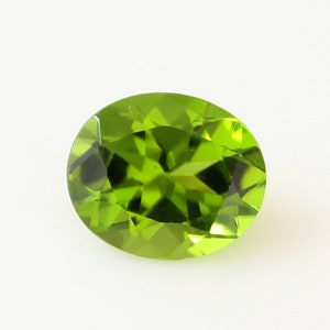 Natural Genuine Peridot Oval Cut, 5.07 Ct. Rare and Exclusive Loose Gemstone In Size 12x10 MM AAA Quality, Inclusion Free.