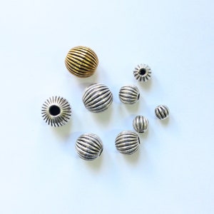 Corrugated Round Spacer Beads in sterling silver with oxidised finish, also available with gold plating.