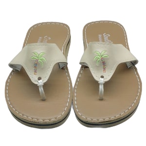 Palm tree sandals with Ivory color strap on suntan footbed