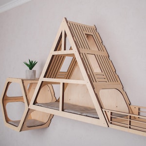 May include: A wooden cat tree shaped like a house with a triangular roof and multiple shelves. The cat tree has a hexagonal shelf on the side and a small plant on top.