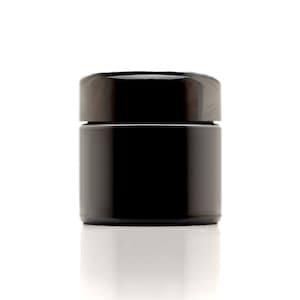 May include: A black glass jar with a black lid. The jar is empty and has a smooth, shiny surface.