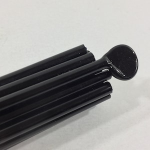TUXEDO black CIM glass rods. COE 104. Sold per 0.25 pound