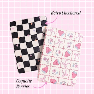 two different designs of notebooks or planners, one with a black and white checkered pattern and the other with a pink and white strawberry pattern. The text above the notebooks reads "Retro Checkered" and "Cocoquet Berries", indicating the design of the notebooks.