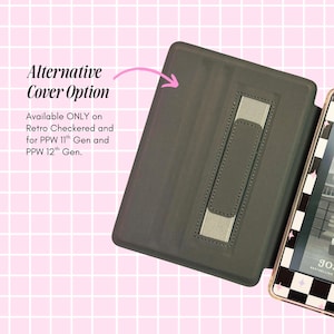 a black cover with a pink handle, placed on a pink background with a checkered pattern.