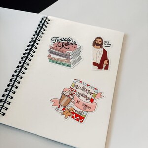 a notebook with stickers on it sitting on a table