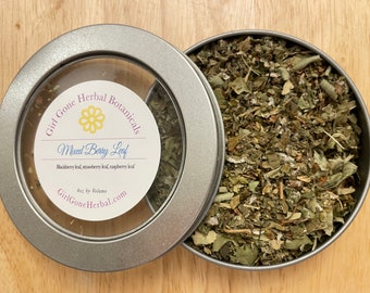 May include: A silver tin with a clear lid containing a dried herb blend labeled "Girl Gone Herbal Botanicals Mixed Berry Leaf Blackberry leaf, strawberry leaf, raspberry leaf 4oz by Volume GirlGoneHerbal.com"
